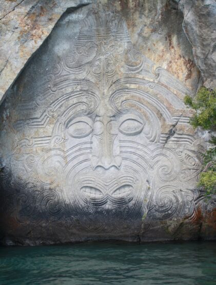 body of water between gray rock formation during daytime